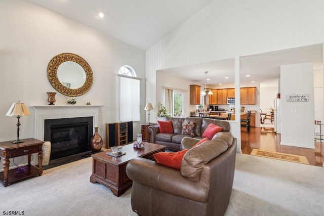 living room featuring light hardwood / wood-style flooring and high vaulted ceiling