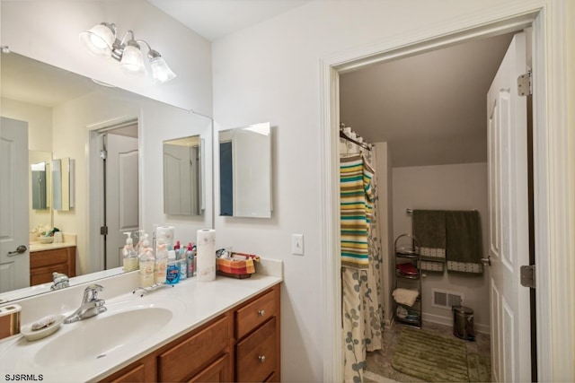 bathroom with vanity and curtained shower