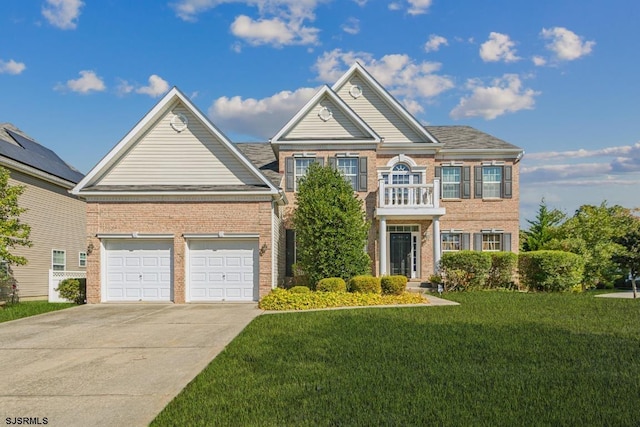 view of front of home with a front yard, a balcony, and a garage