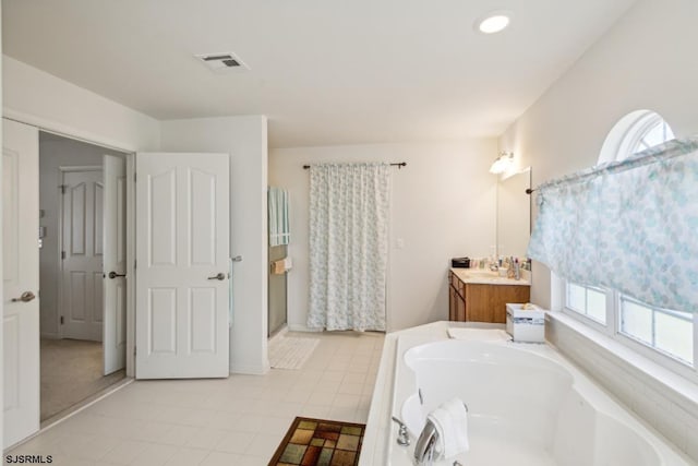 bathroom with vanity, plus walk in shower, and tile patterned floors