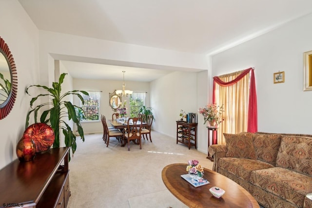 living room with a notable chandelier and light colored carpet