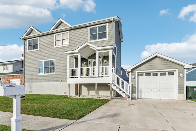 view of front of home with covered porch, a garage, and a front lawn