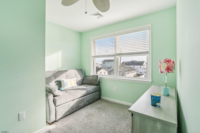 sitting room featuring ceiling fan and light colored carpet