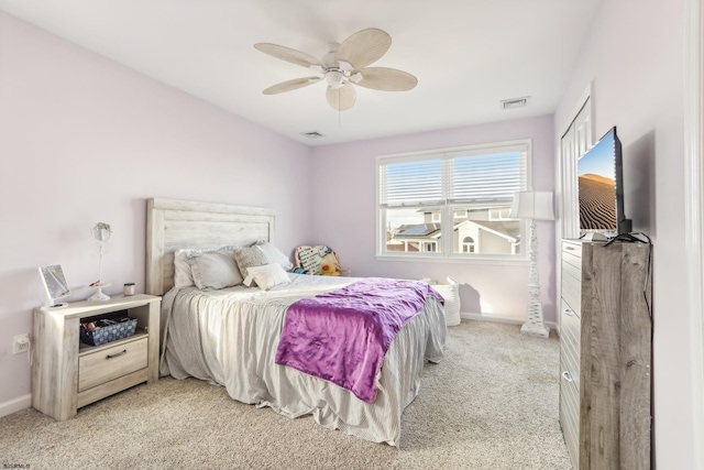 bedroom featuring light carpet and ceiling fan