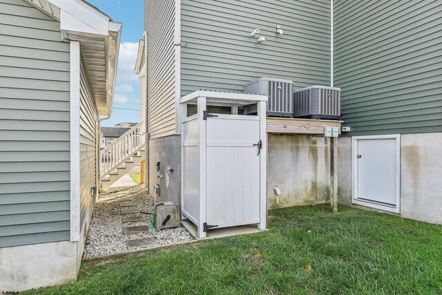 exterior space with a yard and central air condition unit