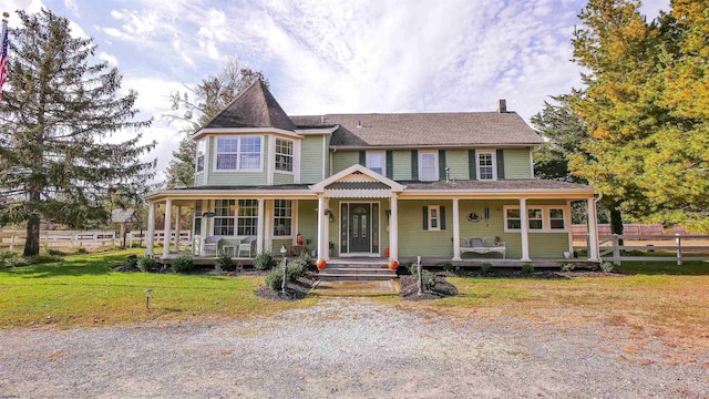 view of front of property with a porch and a front lawn