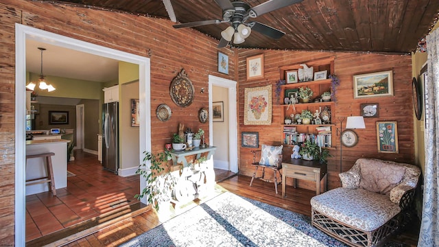 living area with wood ceiling, wood walls, lofted ceiling, and dark hardwood / wood-style flooring