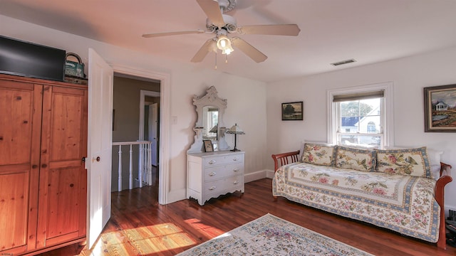 living room with ceiling fan and dark hardwood / wood-style flooring