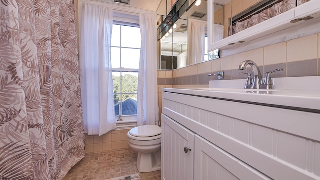 bathroom featuring tile walls, vanity, curtained shower, and toilet