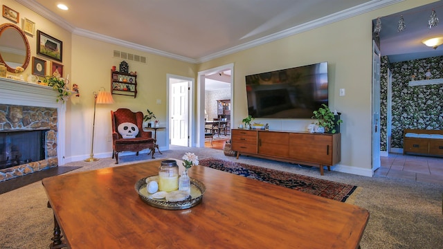 dining room featuring light carpet, crown molding, and a stone fireplace