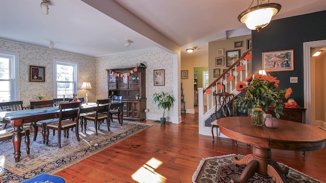 dining room with crown molding and dark hardwood / wood-style floors