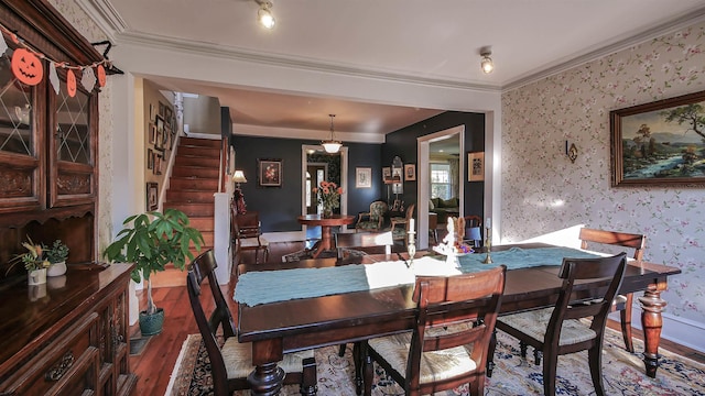 dining room featuring ornamental molding and hardwood / wood-style floors