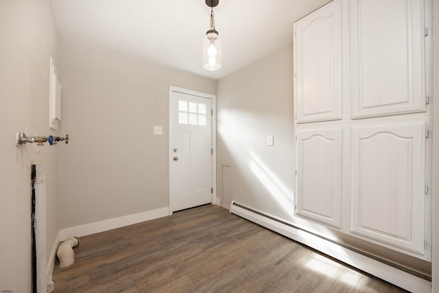 foyer with a baseboard radiator and dark hardwood / wood-style flooring