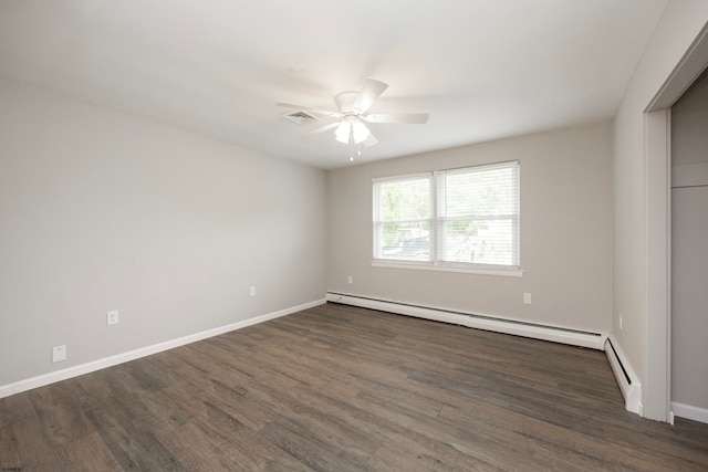 unfurnished room featuring dark hardwood / wood-style floors, baseboard heating, and ceiling fan