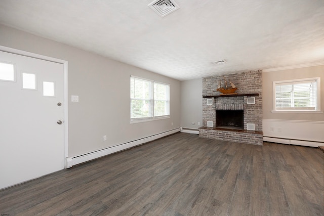 unfurnished living room with baseboard heating, dark wood-type flooring, crown molding, and a fireplace