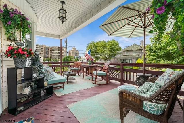 wooden terrace with an outdoor hangout area