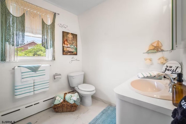 bathroom featuring vanity, toilet, and baseboard heating