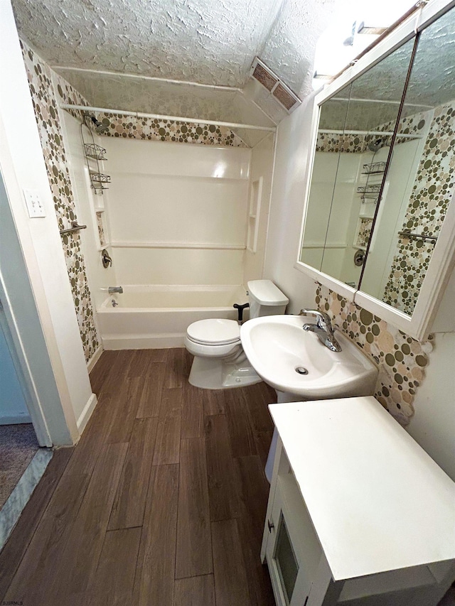 full bathroom featuring bathing tub / shower combination, toilet, vanity, and hardwood / wood-style flooring