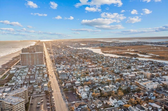 aerial view with a water view and a beach view