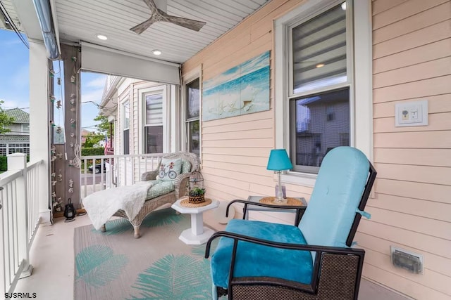 balcony with a porch and ceiling fan