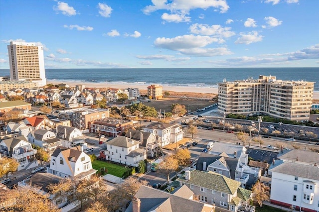 drone / aerial view featuring a water view and a beach view