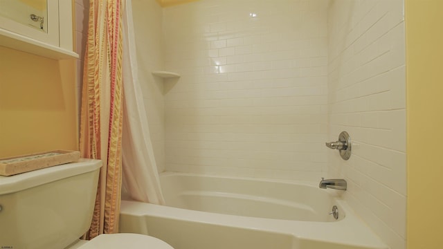 bathroom featuring shower / bath combo and toilet