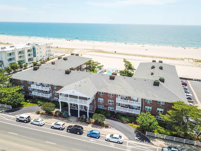 bird's eye view featuring a water view and a view of the beach