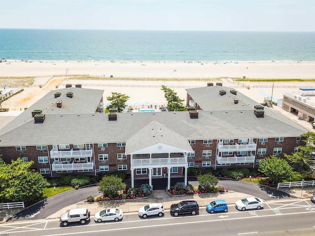 bird's eye view featuring a water view and a view of the beach