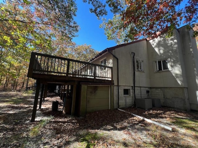 back of property featuring a wooden deck