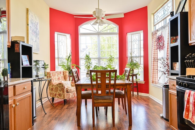 dining area with ceiling fan and dark hardwood / wood-style flooring