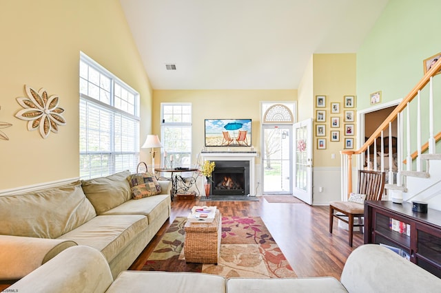 living room featuring high vaulted ceiling and hardwood / wood-style floors