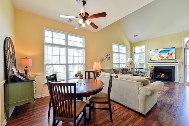 dining area with lofted ceiling, ceiling fan, and dark hardwood / wood-style flooring