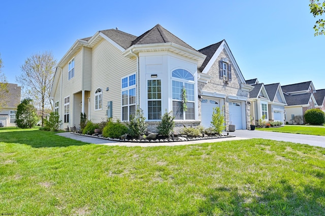 view of front of house featuring a front yard and a garage