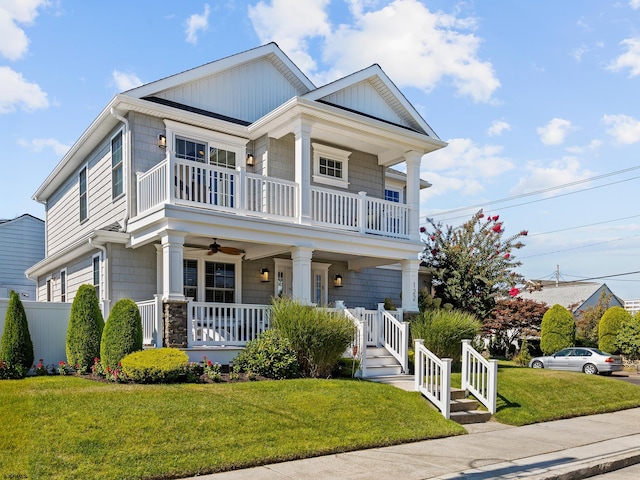 view of front of home with a porch, a front lawn, and ceiling fan