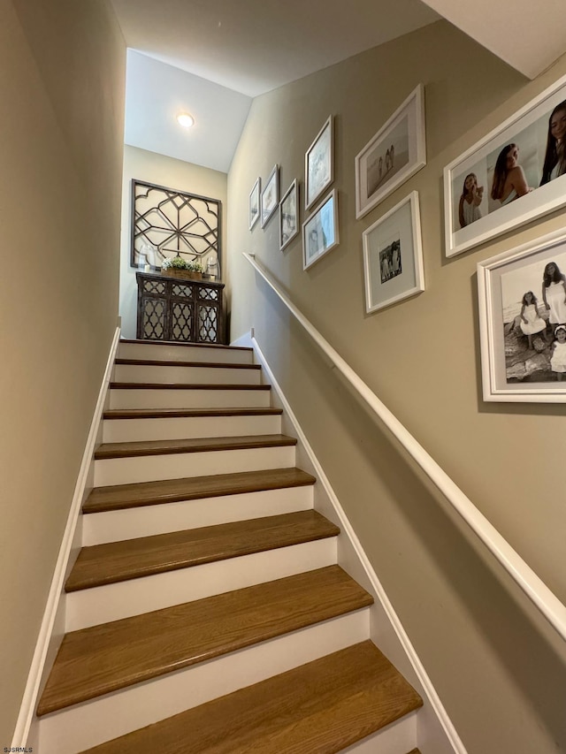 stairway featuring lofted ceiling