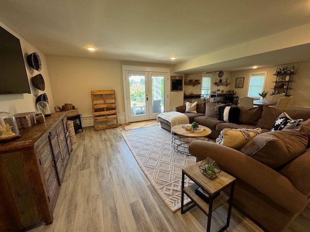 living room featuring french doors and light wood-type flooring