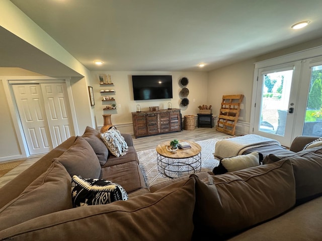 living room featuring french doors and light hardwood / wood-style floors