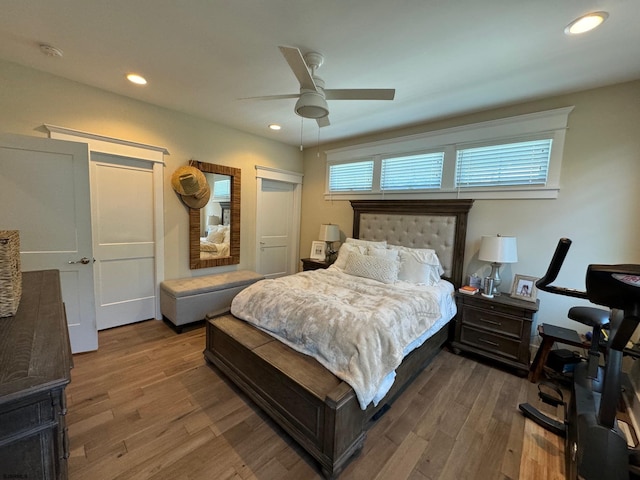 bedroom with multiple windows, ceiling fan, and hardwood / wood-style floors