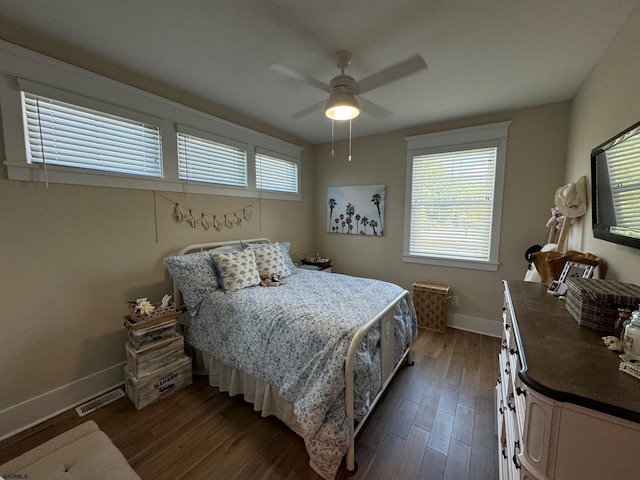 bedroom with ceiling fan and dark wood-type flooring