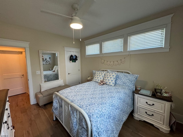 bedroom featuring ceiling fan, dark hardwood / wood-style flooring, and a closet