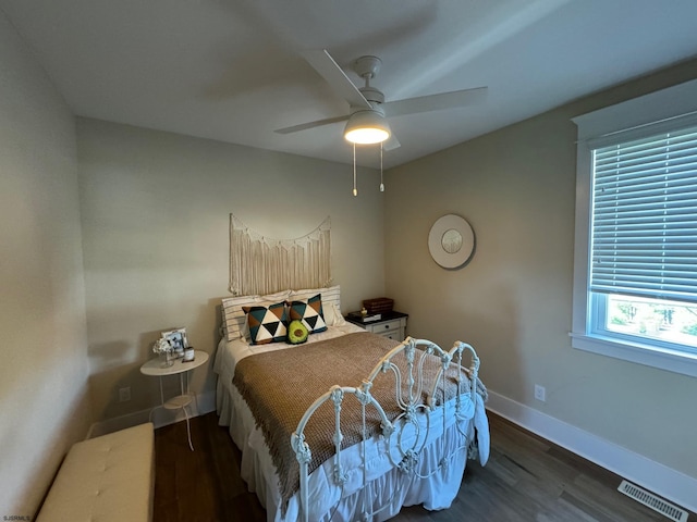 bedroom featuring dark hardwood / wood-style flooring and ceiling fan