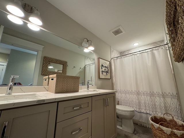 bathroom featuring vanity, toilet, and walk in shower