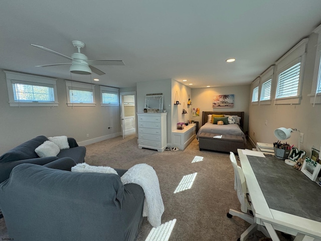 carpeted bedroom featuring ceiling fan and multiple windows