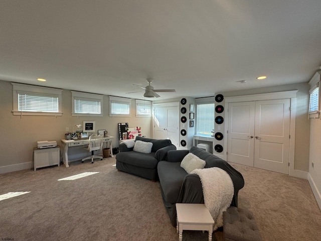 carpeted living room with plenty of natural light and ceiling fan