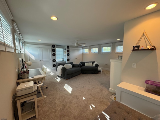 living room featuring carpet floors, plenty of natural light, and ceiling fan