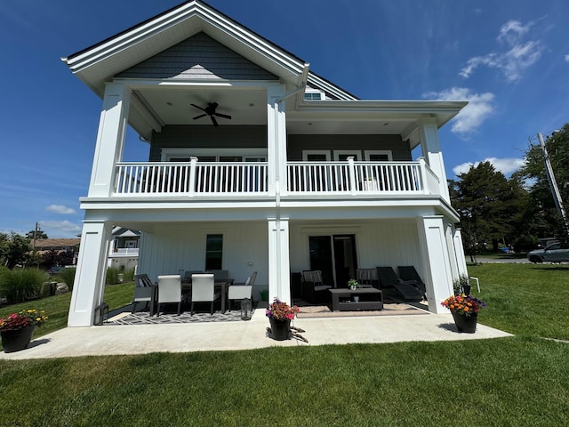 back of property featuring outdoor lounge area, ceiling fan, a yard, a balcony, and a patio area