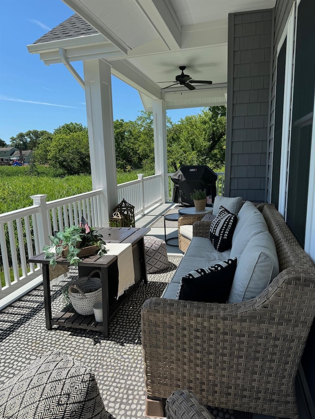 view of patio featuring covered porch, an outdoor living space, area for grilling, and ceiling fan