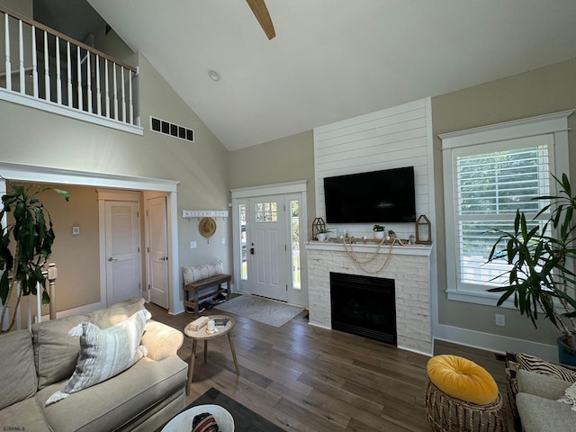 living room featuring a fireplace, dark hardwood / wood-style flooring, high vaulted ceiling, and ceiling fan