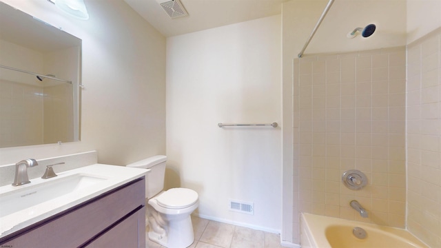 full bathroom featuring vanity, toilet, tile patterned flooring, and tiled shower / bath