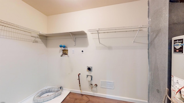 washroom with hookup for a gas dryer, hookup for a washing machine, hardwood / wood-style floors, and electric dryer hookup